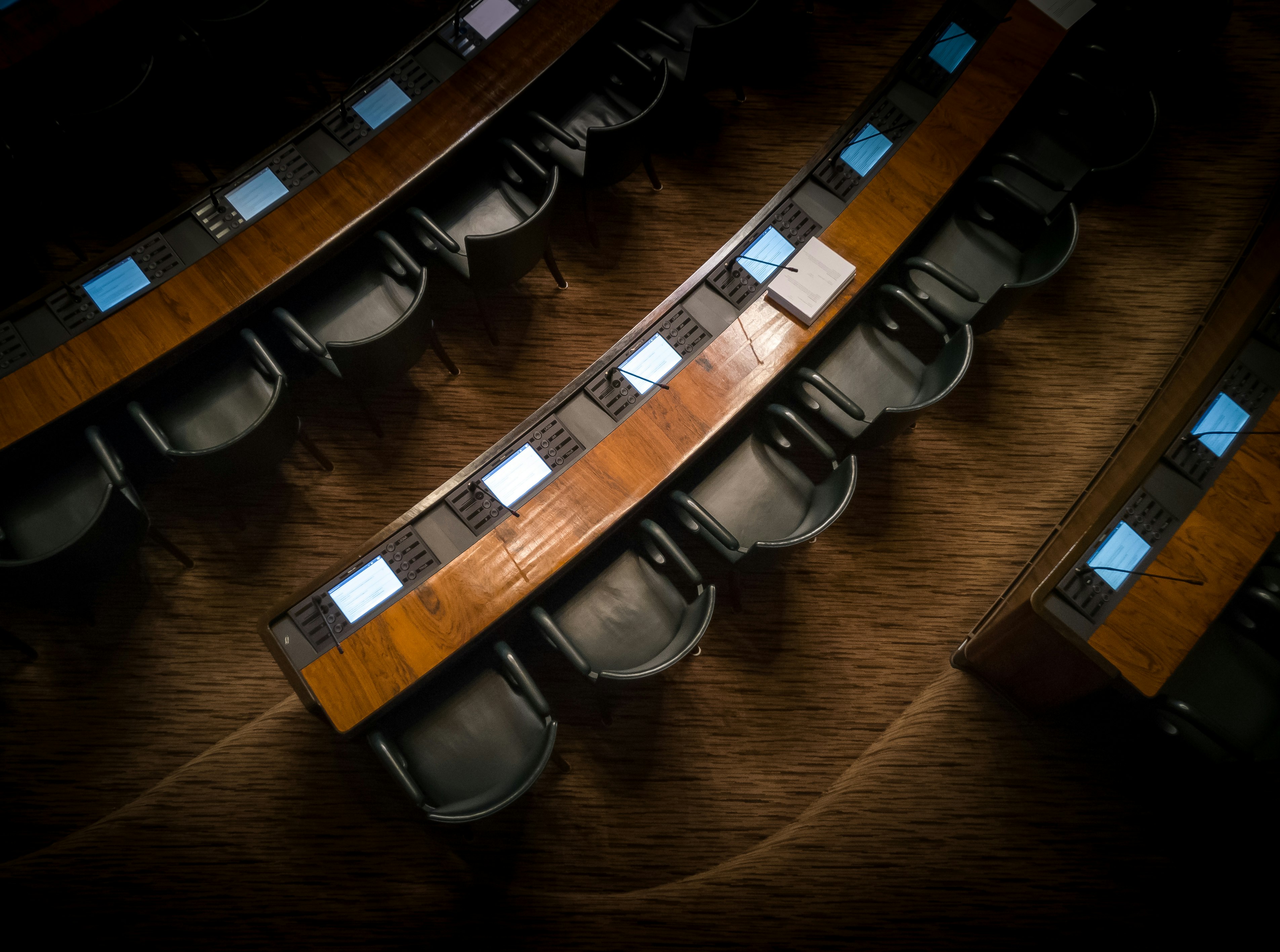 low light photography of armchairs in front of desk